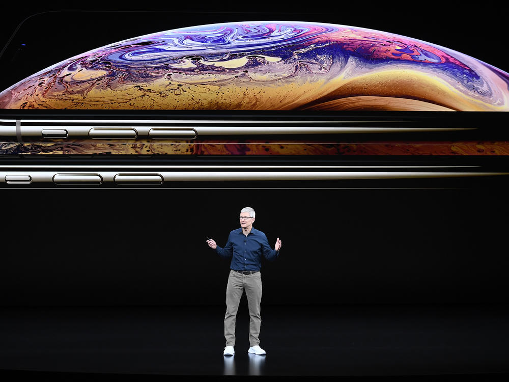 Tim Cook, chief executive officer of Apple Inc., speaks during an event in 2018. Apple is one of 310 companies calling on the Biden administration to slash carbon emissions.