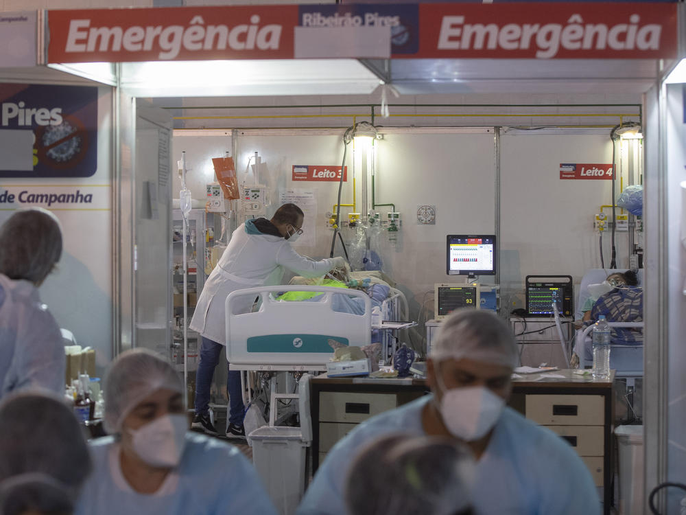 A health worker treats a COVID-19 patient at a field hospital in Ribeirao Pires, greater Sao Paulo area, on Tuesday.