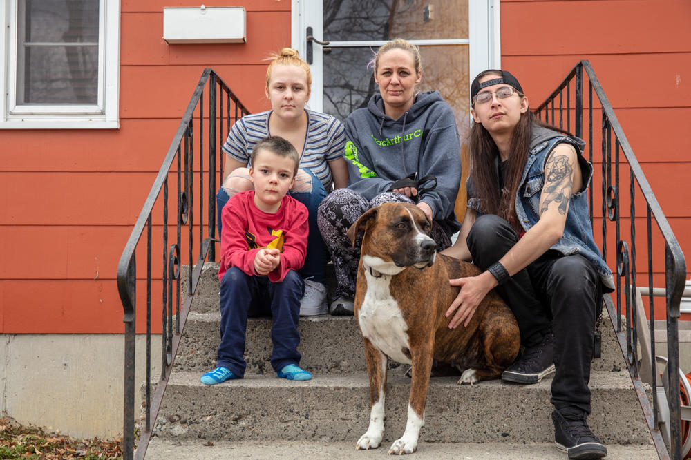 Gaught sits outside the house she now rents in Billings with her three children. The family had to leave suddenly when they were evicted, and still haven't been able to find a cat they had at the mobile home park. 