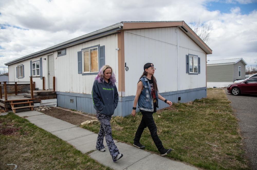 Gaught and her son, Izaah, check on their old home for notices left on the door. Gaught and her family were evicted from the home in a mobile home park in Billings, Mont., owned by Havenpark Communities. The company filed an eviction case against her in November after she fell one month behind on the rent and owed just $621.