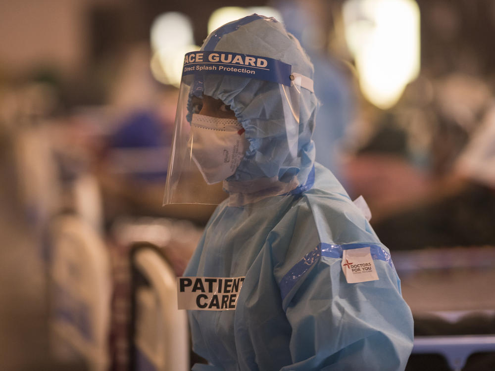 A medical worker is seen at a quarantine center for Covid-19 coronavirus infected patients at a banquet hall, which was converted into an isolation center to handle the rising cases of infection in New Delhi, India.
