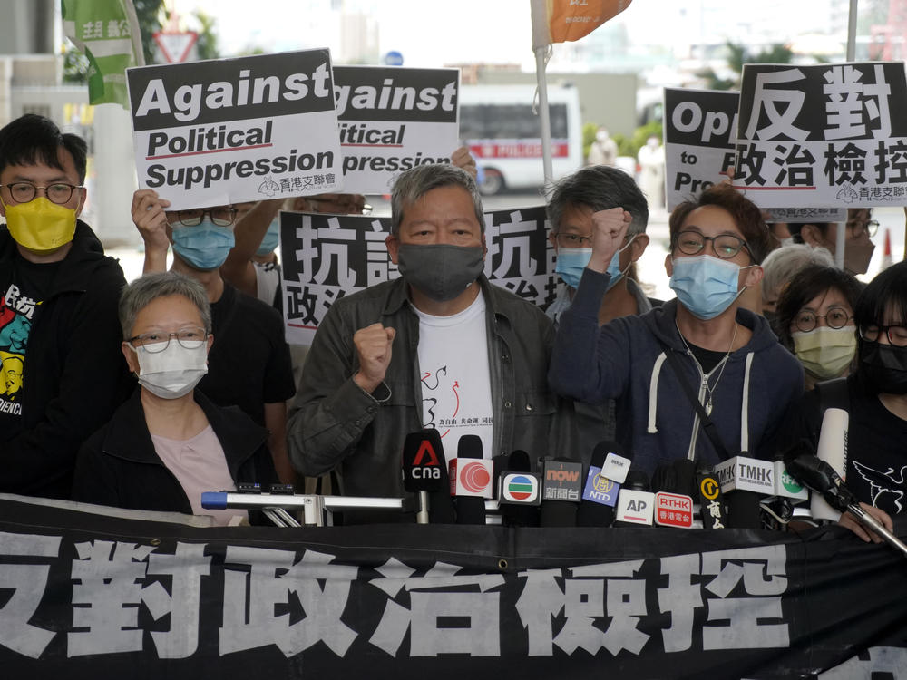 Pro-democracy activist Lee Cheuk-yan, center, arrives at a court in Hong Kong Friday.  Seven of Hong Kong's leading pro-democracy advocates, including Lee, and pro-democracy media tycoon Jimmy Lai, were sentenced Friday for organizing a march during the 2019 anti-government protests.