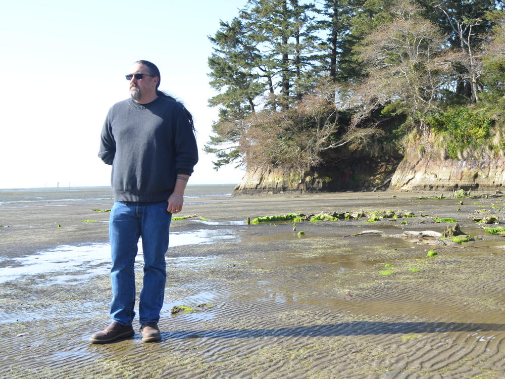 Tony Johnson is chair of the Chinook Indian Nation, a federally unrecognized tribe. He stands on a Willapa Bay, Wash., beach, where he got married and not far from where his ancestors lived.