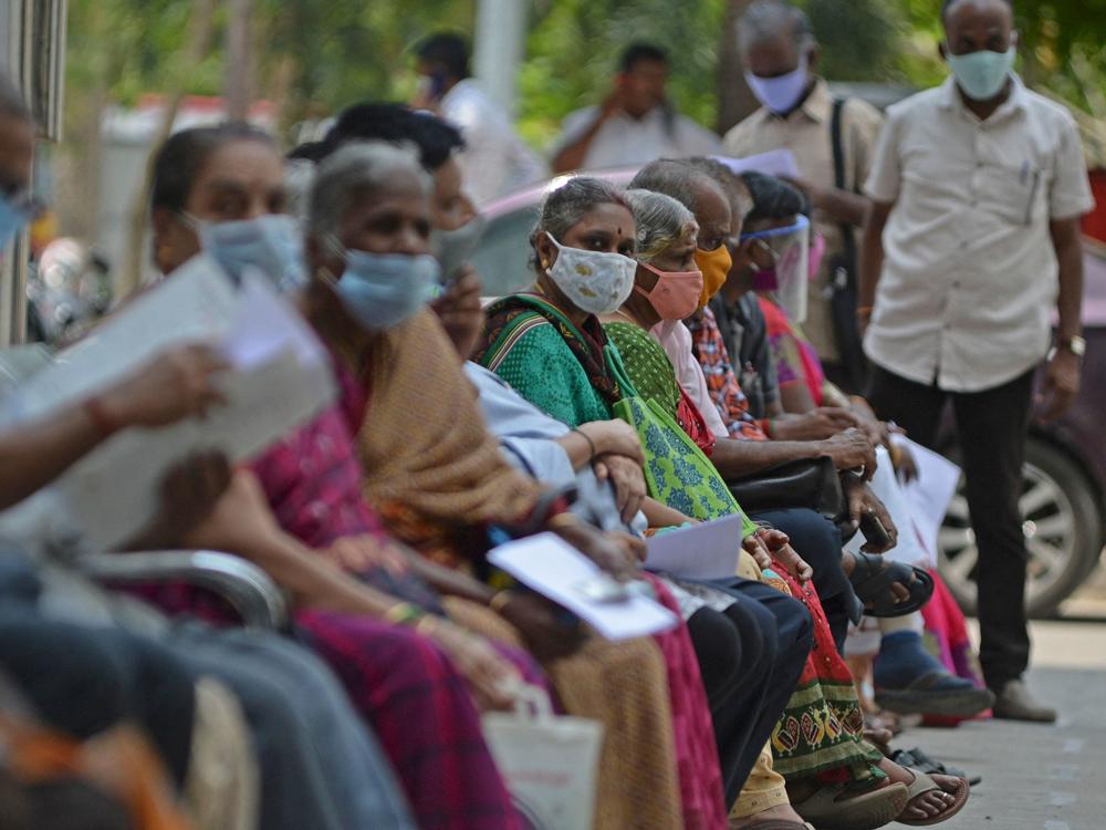 People wait for their turn to receive the COVID-19 vaccine at a government hospital in Chennai, India, on Friday.