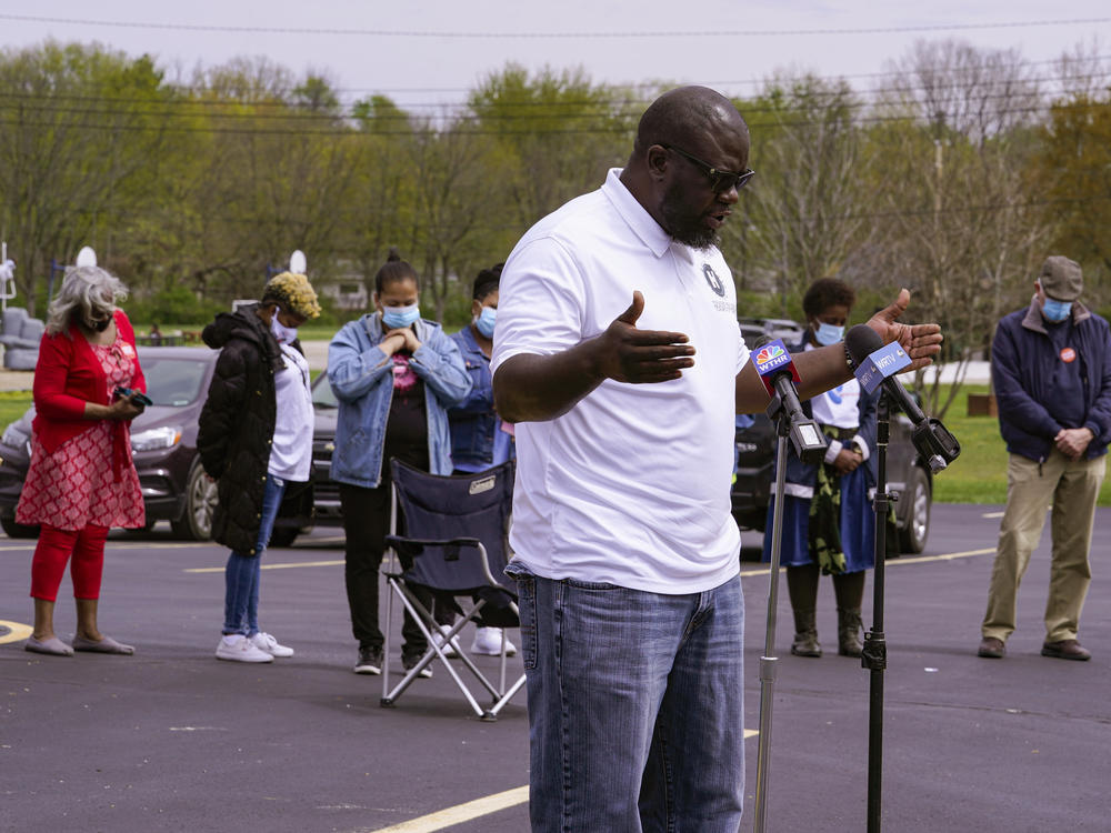 Pastor Denell Howard leads a prayer Saturday at a vigil at Olivet Missionary Baptist Church in Indianapolis for the victims of the shooting Thursday at a FedEx facility.