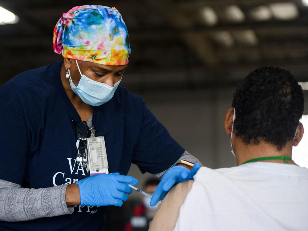 A nurse administers the Moderna COVID-19 vaccine at a Veterans Administration Long Beach Healthcare System pop-up vaccination site at the Dae Hueng Presbyterian Church on Saturday in Gardena, Calif. More than half of U.S. adults have now received at least one vaccine dose.