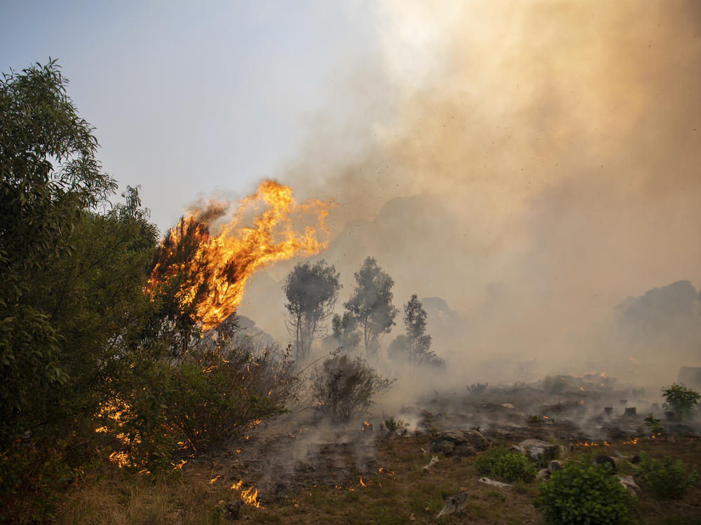 A fire rages out of control on the slopes of Table Mountain in Cape Town, South Africa, Sunday.