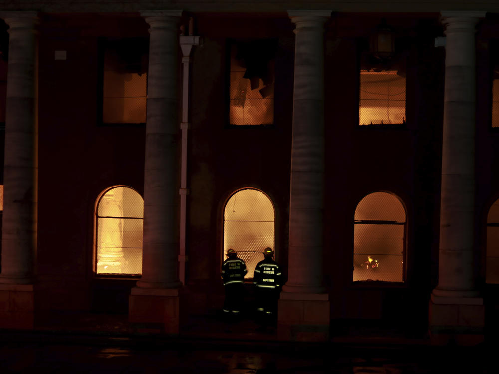 Firefighters douse the destroyed Jagger Library at the University of Cape Town, South Africa. A wildfire raging on the slopes of Cape Town's Table Mountain spread to the university, forcing the evacuation of students.