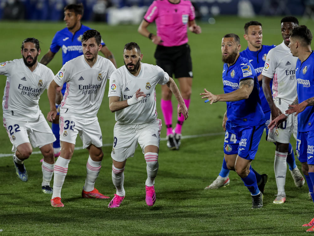 Real Madrid players, left, duel with Getafe players during the Spanish La Liga soccer match at the Alfonso Perez stadium in Getafe, Spain, Sunday.