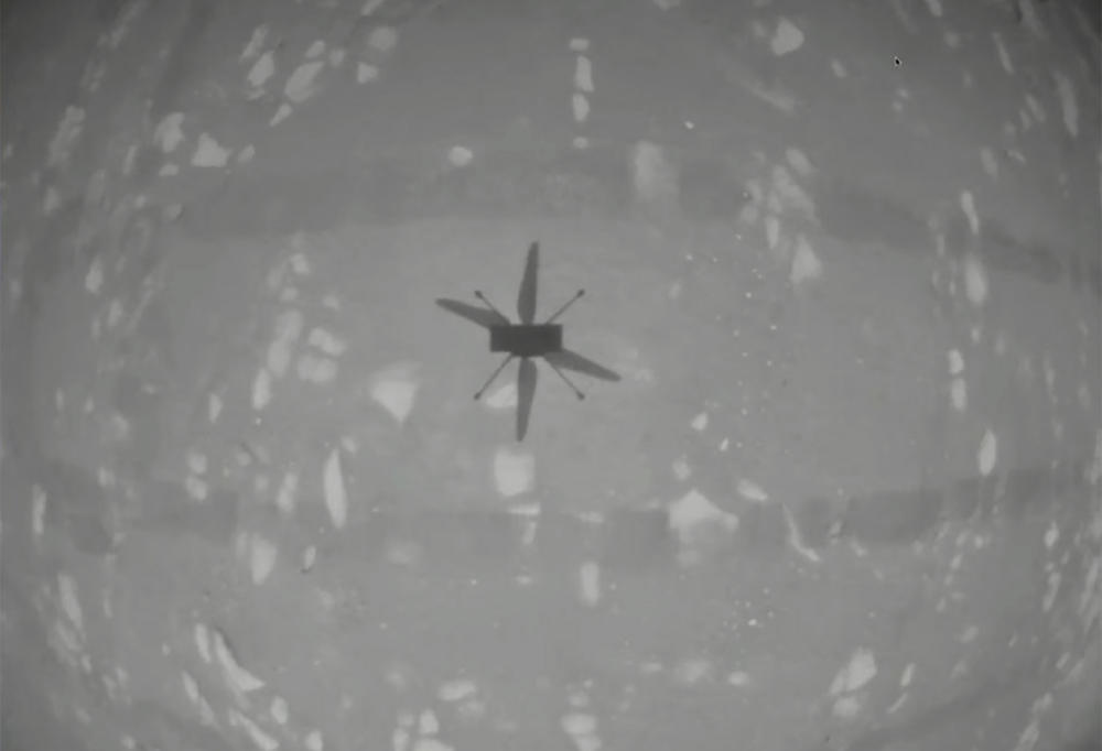 Ingenuity hovers above the surface of Mars on Monday. The small experimental helicopter rose from the dusty red surface into the thin Martian air, achieving the first powered, controlled flight on another planet.