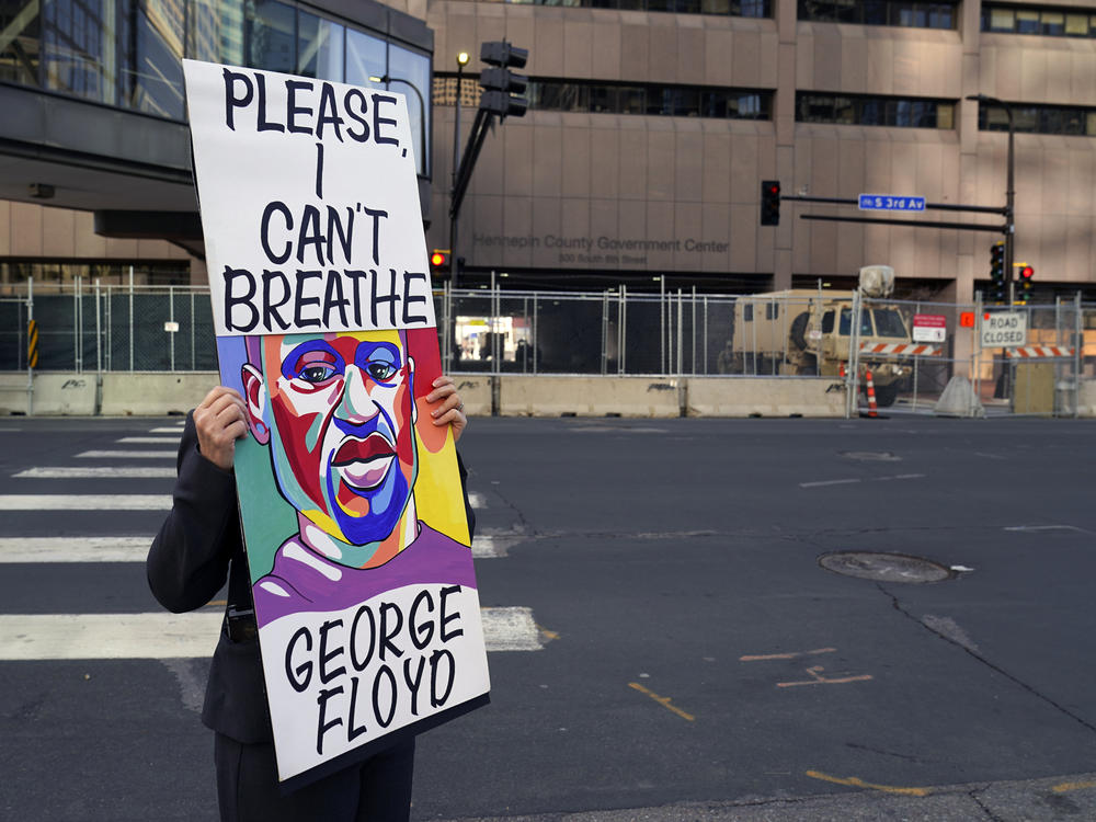 A protester holds a sign across the street from the Hennepin County Government Center in Minneapolis on April 6 during the trial of former police officer Derek Chauvin. The testimony ran for three weeks.