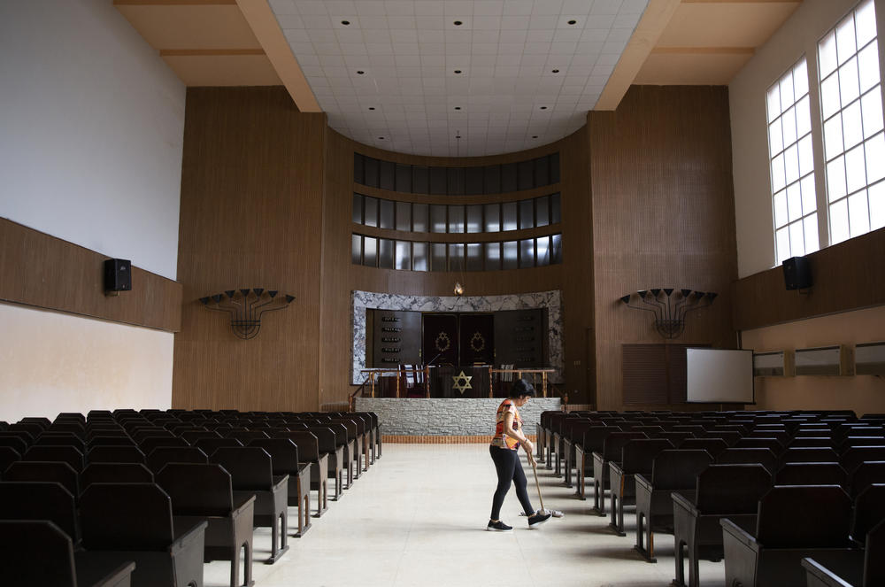 A volunteer at the Beth Shalom synagogue in Havana sweeps the floor of the temple on Jan. 16, 2020.
