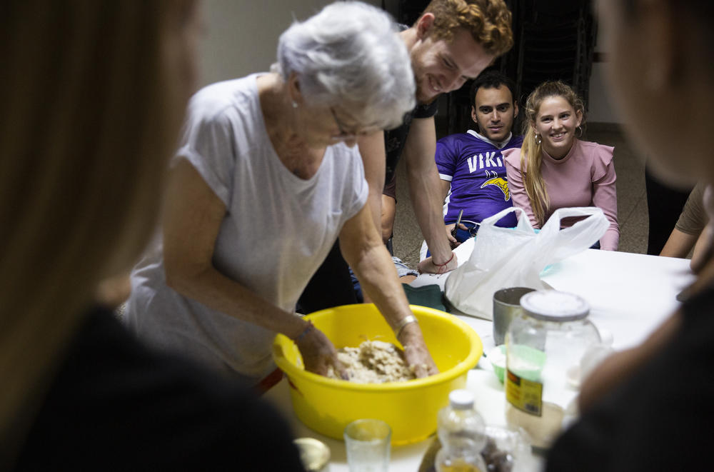 Adri and the synagogue's other youth group members learn how to make challah from Ida, a synagogue elder, on Jan. 18, 2020.
