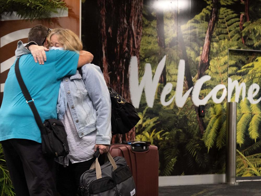 Families are reunited as travelers arrive on the first flight from Sydney in Wellington on Monday after Australia and New Zealand opened a trans-Tasman quarantine-free travel bubble.