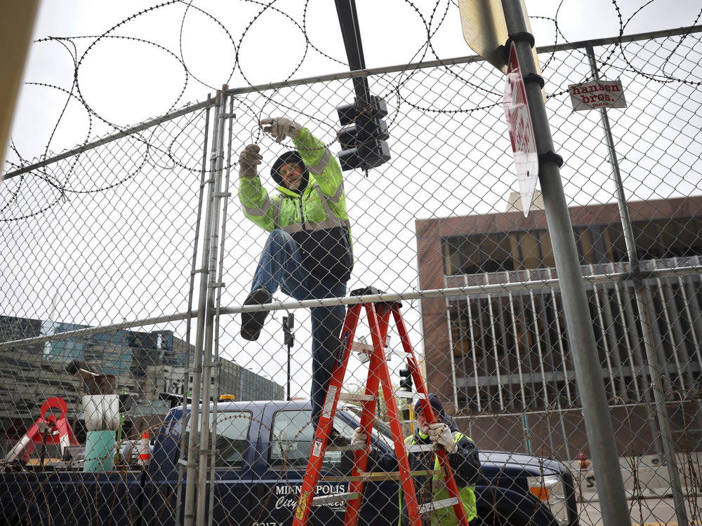 Workers in downtown Minneapolis set up new fences and barbed wire around government buildings over the weekend ahead of a possible verdict this week.