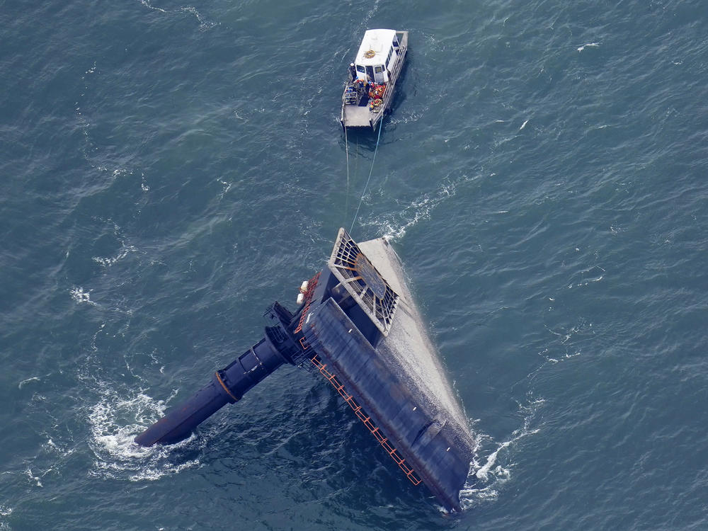 A rescue boat is seen next to the capsized lift boat Seacor Power seven miles off the coast of Louisiana in the Gulf of Mexico Sunday. The vessel capsized during a storm last Tuesday.