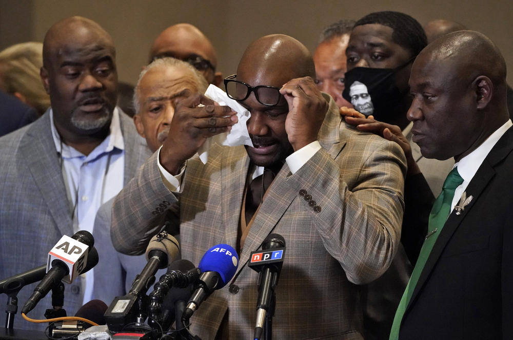 George Floyd's brother Philonise Floyd wipes his eyes during a news conference.