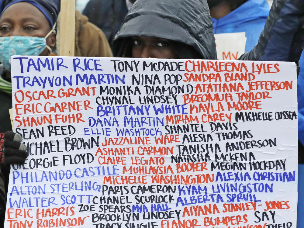 A sign at a June 2020 protest against racial injustice and police violence in Seattle bears the names of people killed by police.