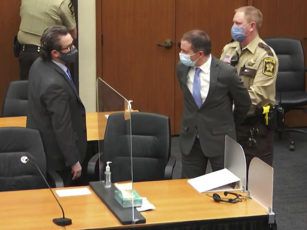 Former Minneapolis police officer Derek Chauvin is taken into custody as his attorney, Eric Nelson, looks on after the verdicts were read on Tuesday at Chauvin's trial for the 2020 death of George Floyd.