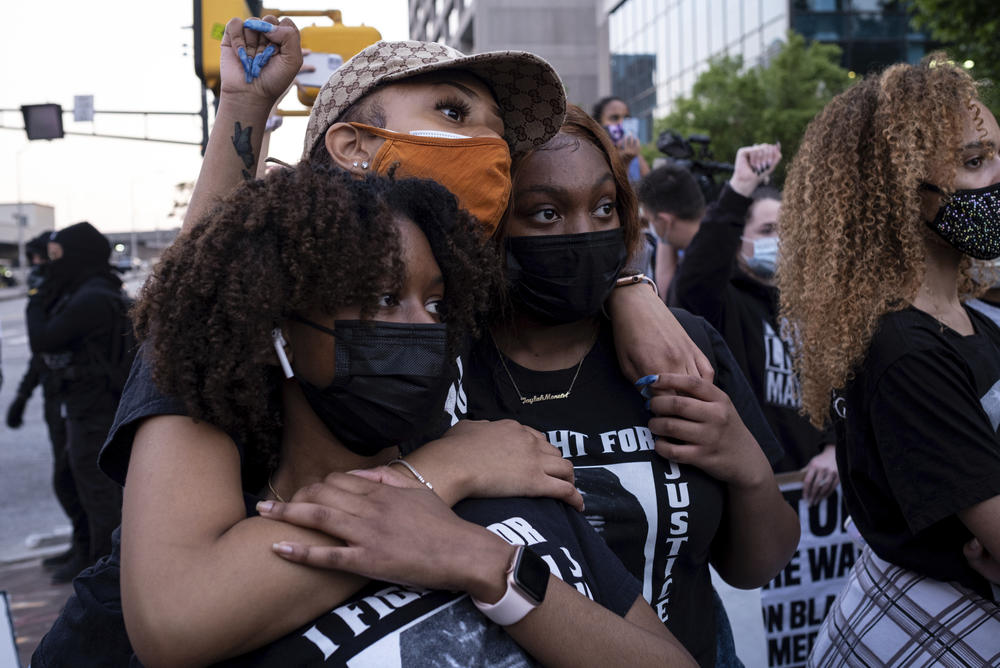Chiara Campbell, from left, Nyasia Thompson and Jaylah Lesesne embrace following a march through downtown Atlanta after Derek Chauvin was found guilty.
