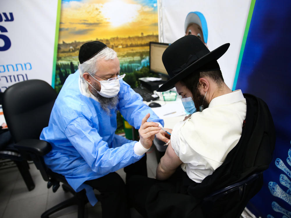 An Ultra-Orthodox Jewish man receives a dose of the Pfizer-BioNtech vaccine in the Israeli city of Bnei Brak in February.