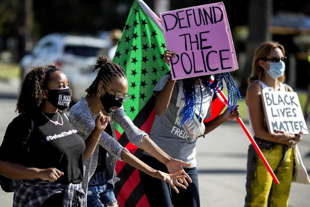 People protest outside Los Angeles Mayor Eric Garcetti's house after a guilty verdict was announced.