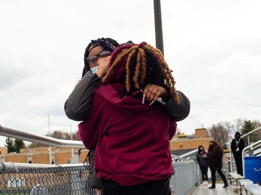 Samiyyah Wadley, 16, is greeted by classmates after singing during a walkout at Tartan High School in Oakdale, Minn.