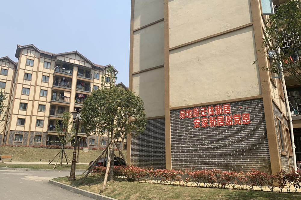 Apartments in Qixingguan, a new district in Bijie, China, were built for the residents of poor, remote villages. A patriotic slogan on one building says: 