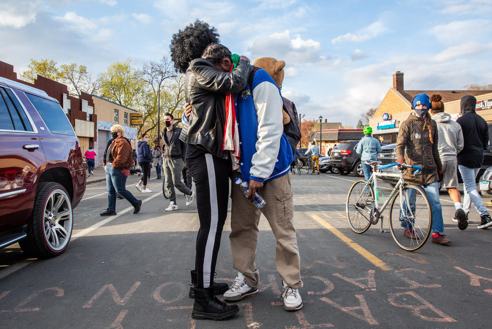 Michael Wilson, right, hugs Pamela Weems at George Floyd square.