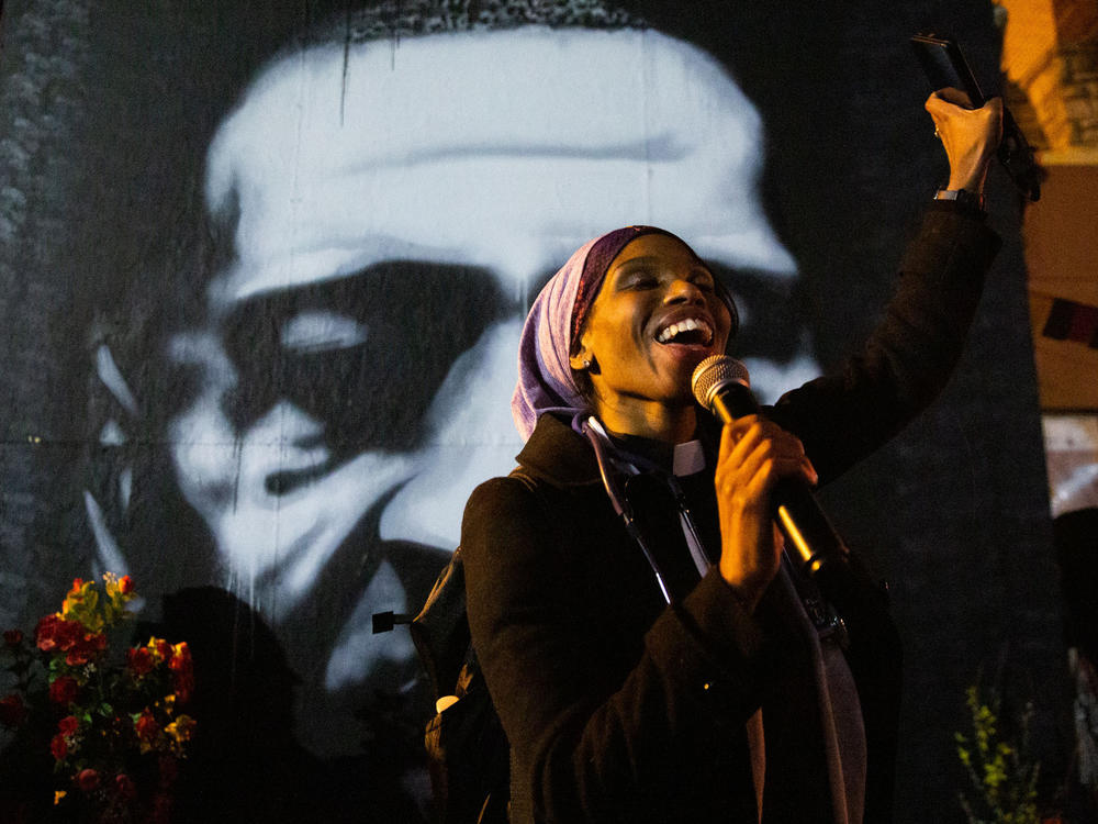 Jeanette Rupert smiles as she speaks to the crowd at George Floyd square in front of 