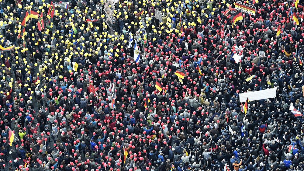People hold balloons in the colors of the German national flag during a 2018 rally of a group called Patriotic Europeans Against the Islamization of the West, or PEGIDA, in Dresden, Germany.