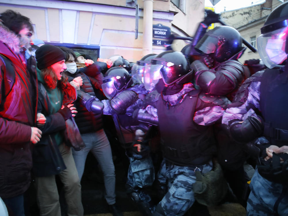 People clash with police during a protest in support of jailed opposition leader Alexei Navalny in St. Petersburg, Russia, Wednesday. A human rights group that monitors political repression said at least 1,700 people were arrested across the country in connection with the protests.
