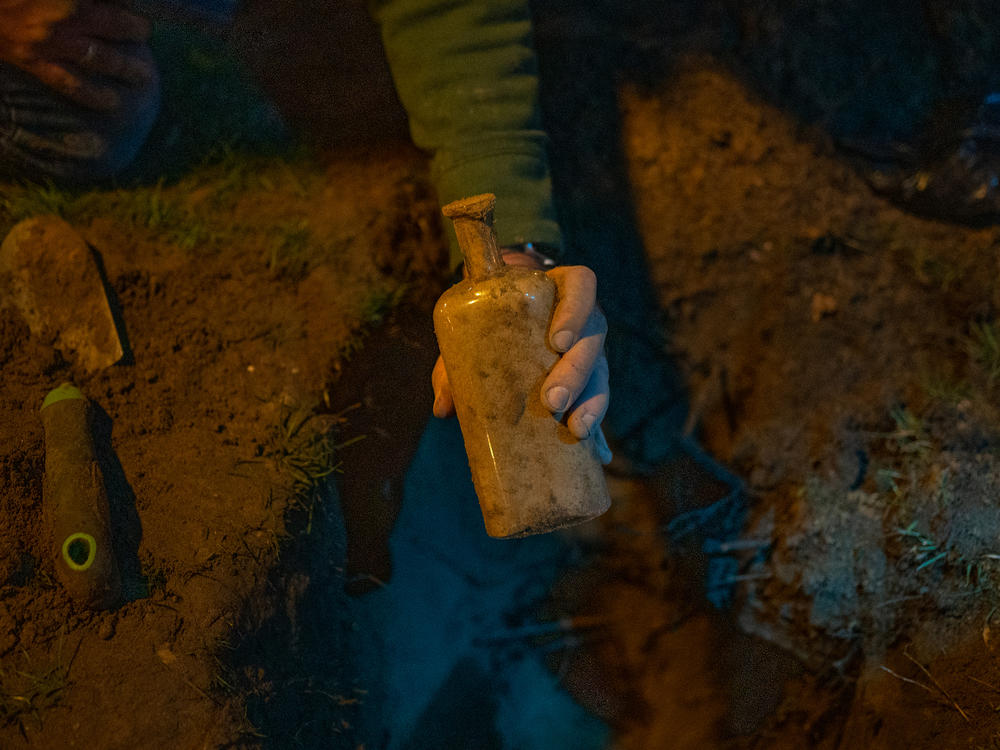 Researchers search for a bottle filled with seeds that was buried 142 years ago as part of a seed germination study.