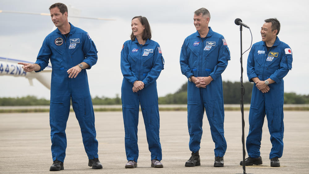 European Space Agency astronaut Thomas Pesquet (from left), NASA astronauts Megan McArthur and Shane Kimbrough, and Japan Aerospace Exploration Agency astronaut Akihiko Hoshide react to comments after arriving at the Launch and Landing Facility at NASA's Kennedy Space Center ahead of SpaceX's Crew-2 mission.
