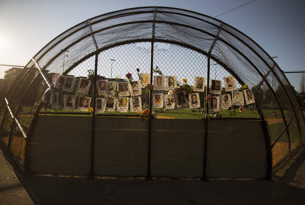 Photographs and flowers remain following a Trans Lives Matter vigil, shown here after the reading of the guilty verdict in the trial of Derek Chauvin in the murder of George Floyd at Cal Anderson Park in Seattle.