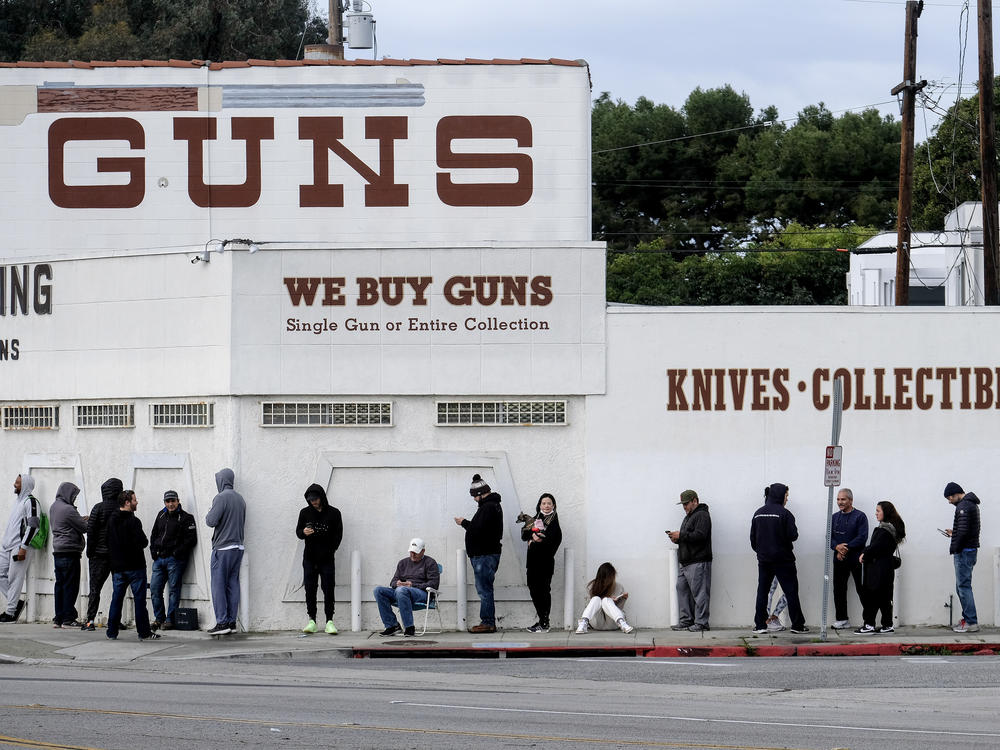 People wait in line to enter a gun store in Culver City, Calif., on March 15, 2020.