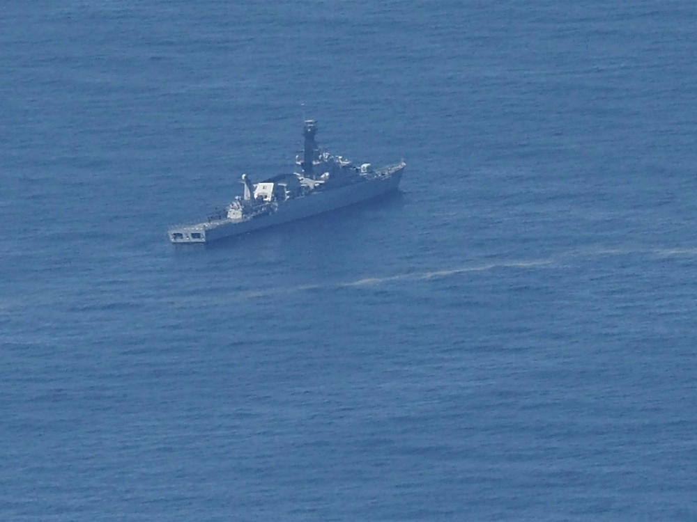 An Indonesian navy ship searches for the submarine KRI Nanggala 402 that went missing this week in the waters off Bali.