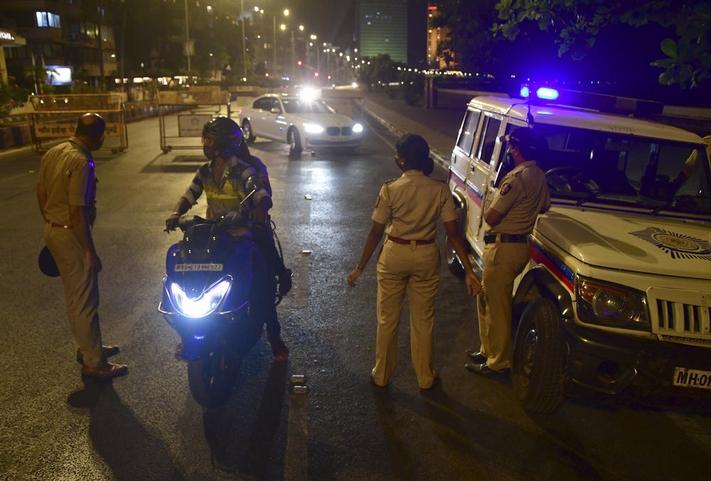 Police check commuters in Mumbai during a planned 15-day lockdown that began on April 14, closing all businesses, services, activities and public places except those deemed essential.