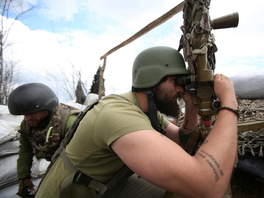 A Ukrainian serviceman looks through a periscope at his position on the fronline against Russia-backed separatists, not far from Donetsk, Ukraine, on Thursday.