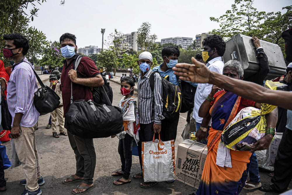 Migrant workers line up to enter a railway station in Mumbai on April 14 hoping to leave the city ahead of a lockdown.