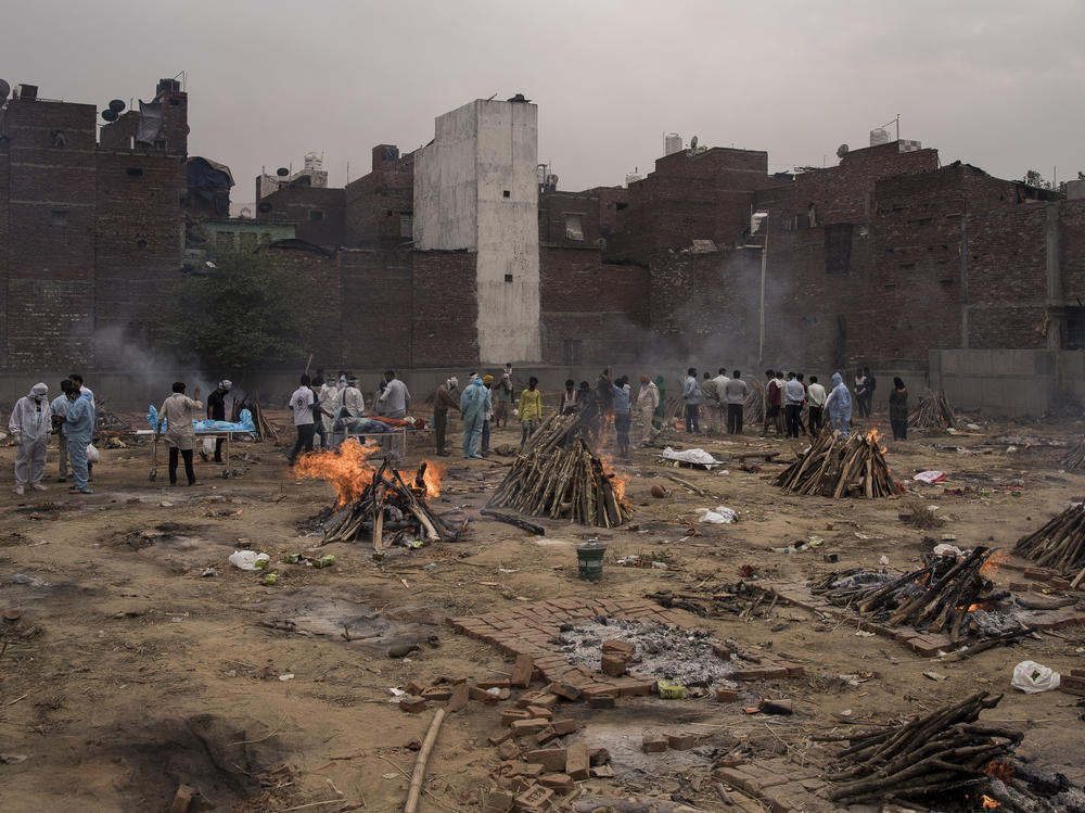 Funeral pyres for patients who died of COVID-19 are seen burning this week at a makeshift crematorium in New Delhi.