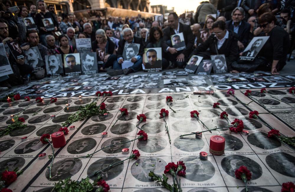 People hold portraits of Armenian intellectuals who were detained and deported in 1915 during an April 24, 2018, rally in Istanbul commemorating the anniversary of those atrocities against Armenians in the Ottoman Empire.