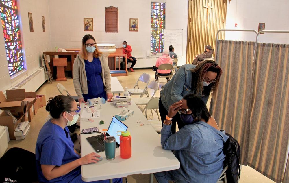 Vivian Satchell (right) receives her second dose of COVID-19 vaccine from registered nurse Elizabeth Lash during a Sayre Health vaccine clinic at Tabernacle Lutheran Church in West Philadelphia. Also pictured (from left) are Dr. Alexandra Stough and medical assistant Alexis Wright.