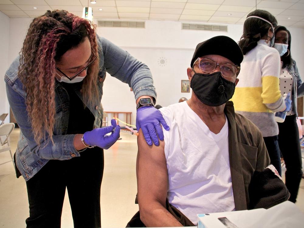 Thomas W. Munson receives his second dose of COVID-19 vaccination from registered nurse Elizabeth Lash at a Sayre Health clinic held at Tablenacle Lutheran Church in West Philadelphia.