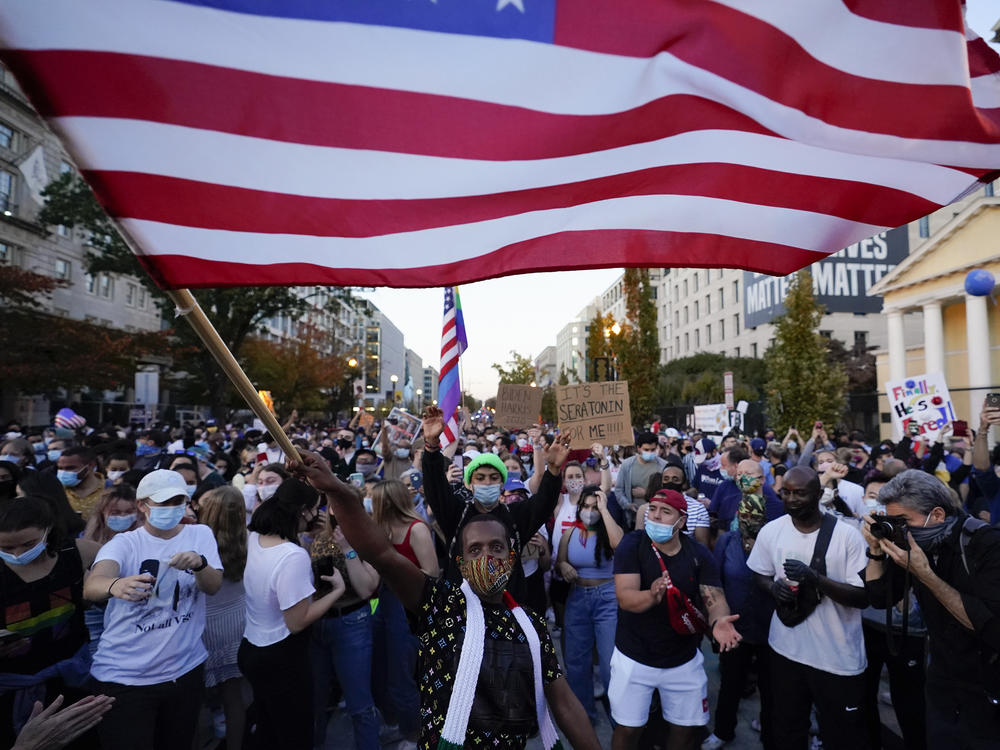 People gather in Black Lives Matter Plaza to celebrate president-elect Joe Biden's win over President Donald Trump on Nov. 7 in Washington, D.C. A new Harvard poll shows the youngest voting-age Americans are more politically active and optimistic about the future than four years ago.
