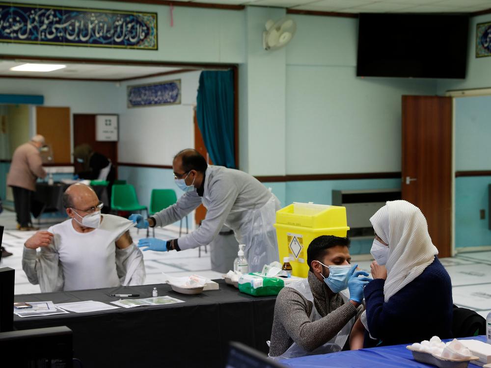 People receive the AstraZeneca COVID-19 vaccine at the Al-Abbas Islamic Center, converted into a vaccination clinic in Birmingham, England, in January. Sheikh Nuru Mohammed, the imam at the mosque, recognized many of his congregants were hesitant to get the 