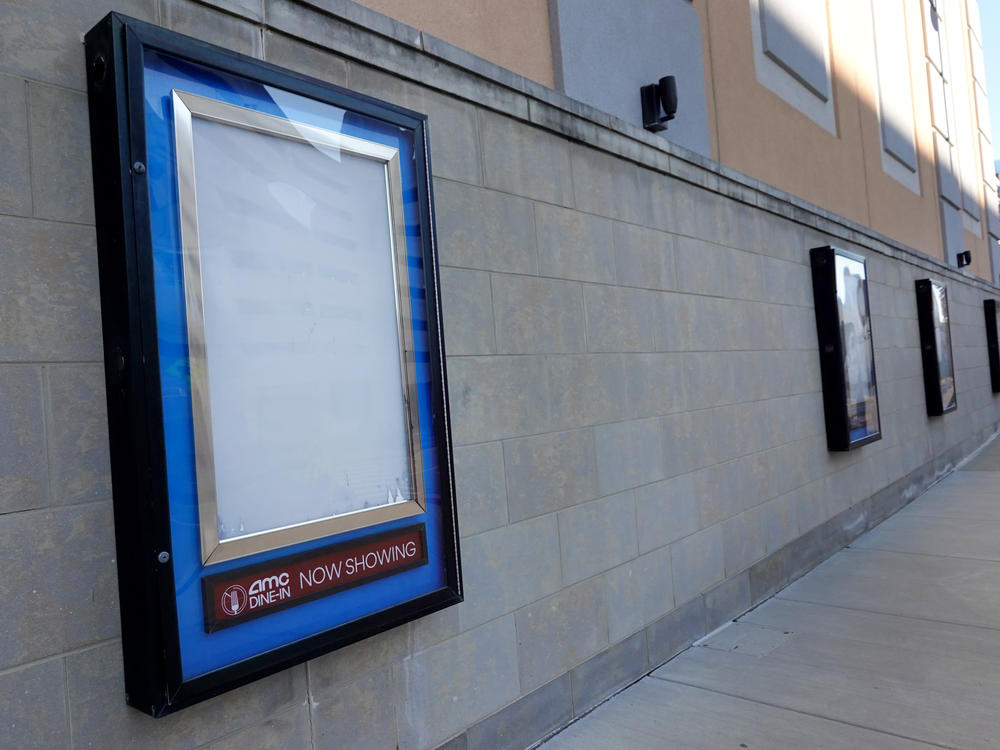 Empty frames that would normally hold movie posters hang on the front of an AMC theater shuttered by the coronavirus pandemic on Dec. 4, 2020, in Rosemont, Ill.
