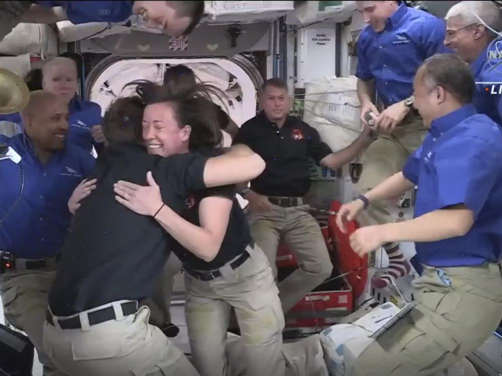 In this image provided by NASA, SpaceX astronauts are greeted by those already aboard the International Space Station after the Dragon capsule successfully docked on Saturday. Their arrival brings the total number of astronauts on the station to a recent high of 11.
