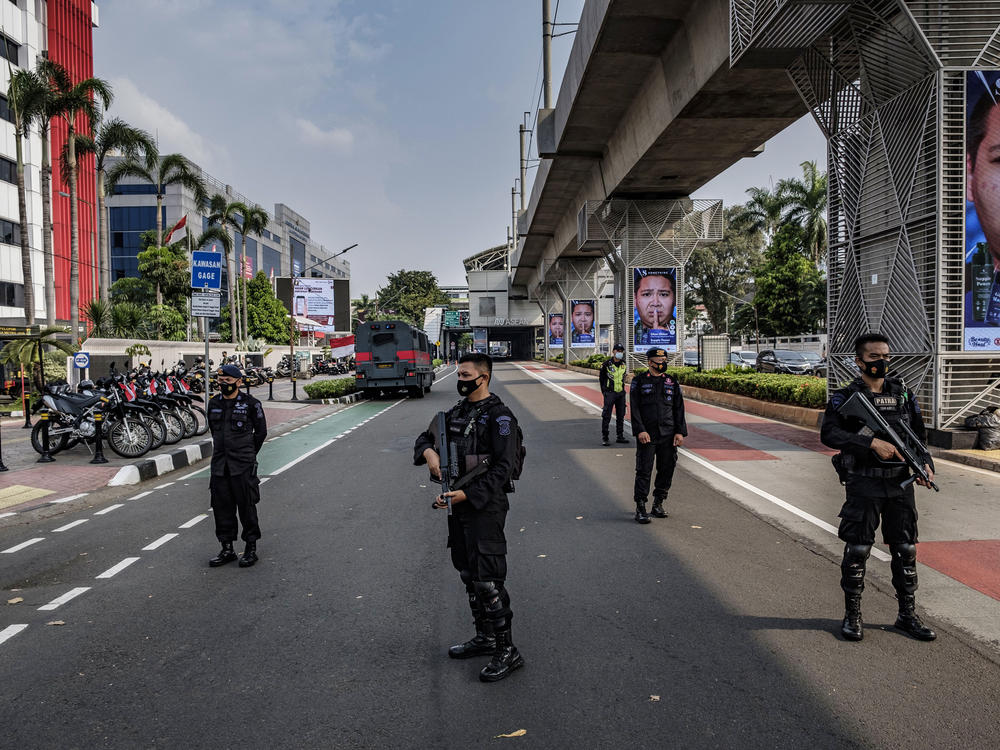 Indonesian police guard the site of Saturday's ASEAN emergency summit in Jakarta, which drew protests over the invitation of Myanmar's military general.