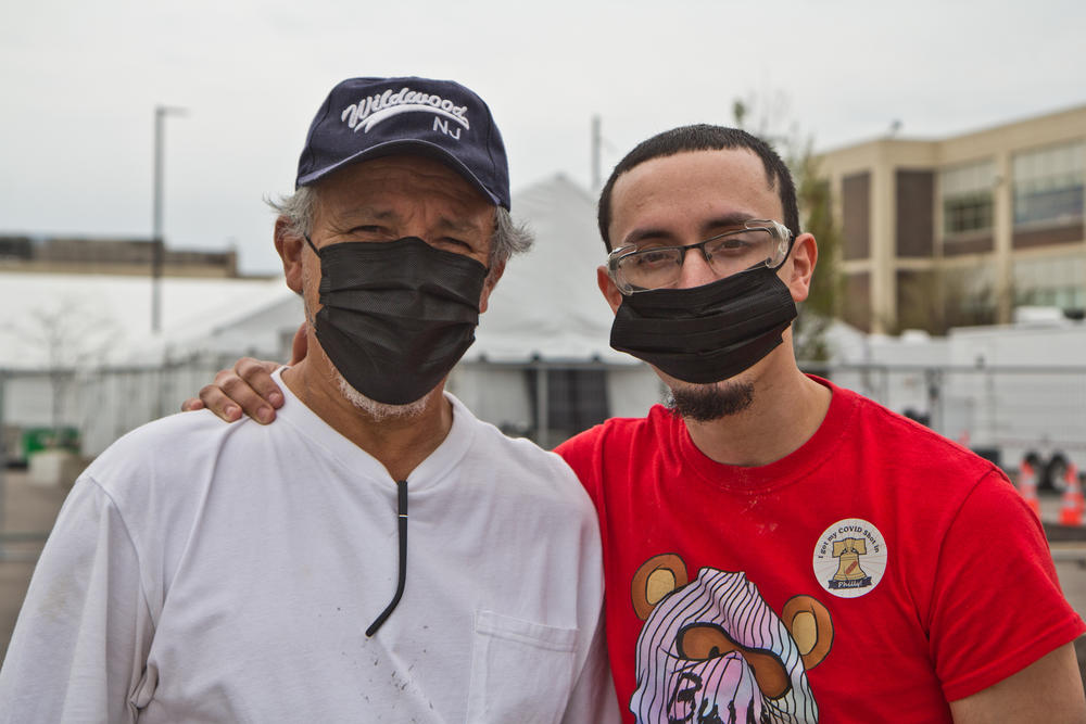 Jeremy Ocasio (right) got vaccinated recently at the Esperanza clinic in North Philadelphia with help from his father, Felipe Ocasio, who lives nearby.